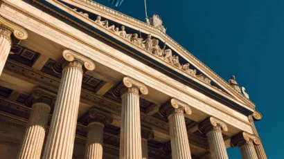 Neoclassical public building with Greek flag in Athens