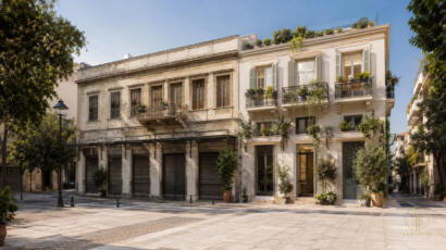 Conceptual Athens streetscape joining shuttered commercial bays and bright planted residential balconies, illustrating adaptive reuse and housing policy.